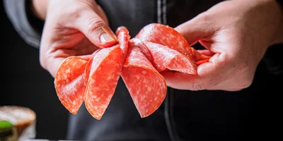 А лепестки сырокопчёной колбасы «Монреаль» наш бренд-шеф решил соединить с помощью зубочистки