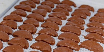 Высушенные апельсиновые дольки, покрытые хрустящим тёмным и&nbsp;молочным шоколадом, обладают выразительным пряным вкусом с&nbsp;приятной фруктовой кислинкой